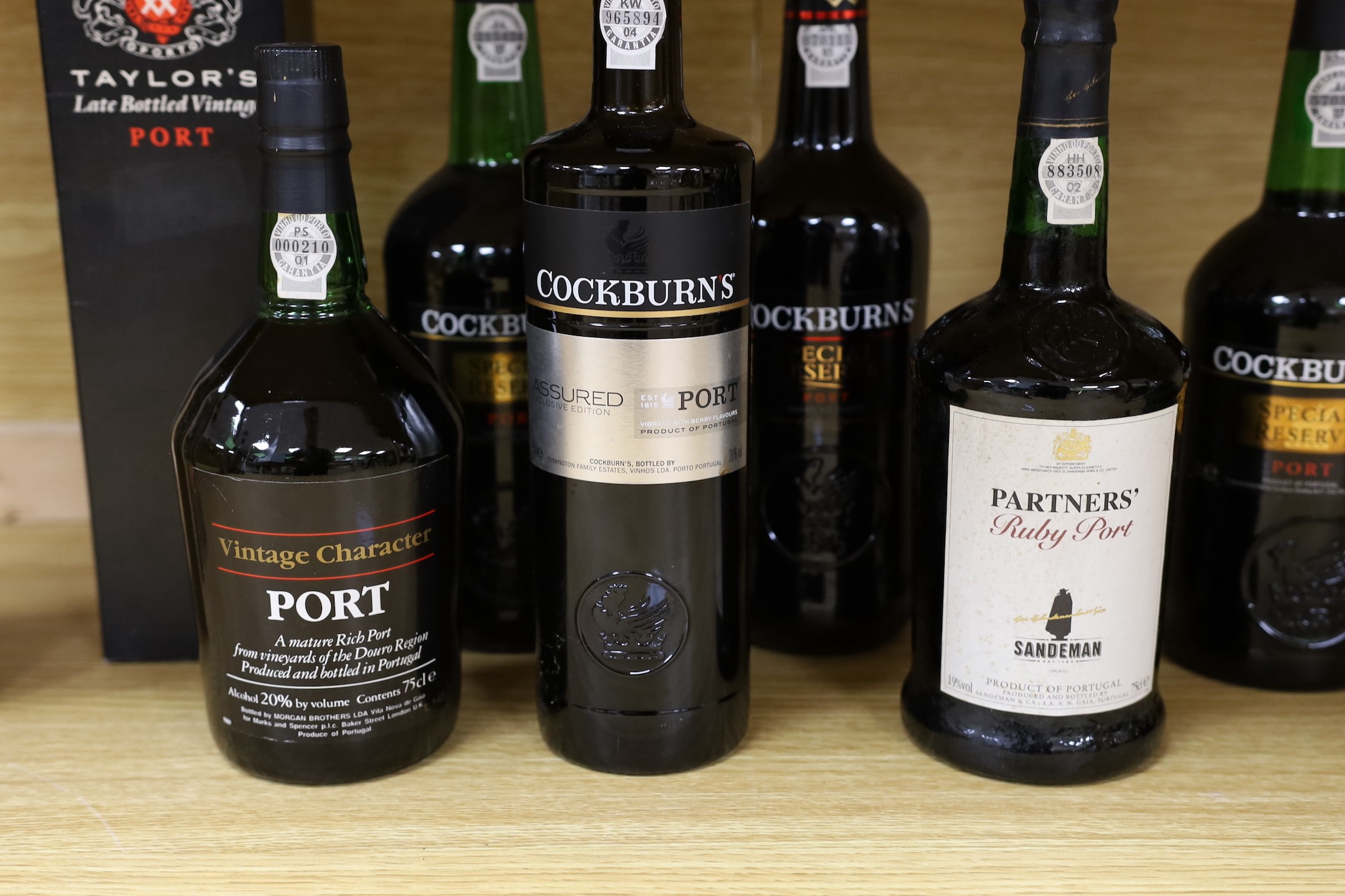 A cased 1996 bottle of vintage Cockburn’s port, together with seven other bottles of various port